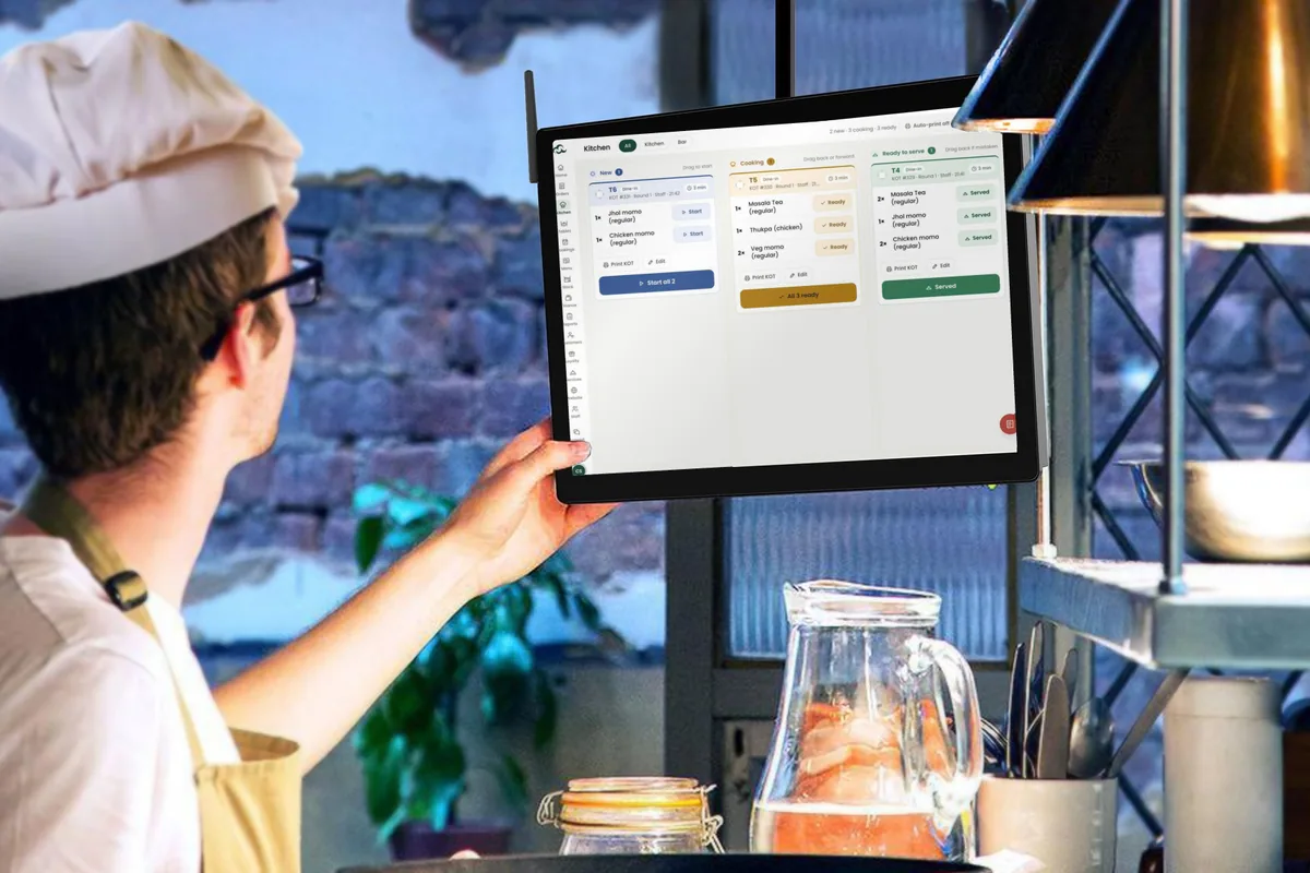 A chef checking the Cloudora Kitchen kitchen screen during service